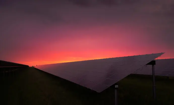 black solar panel under red and gray clouds